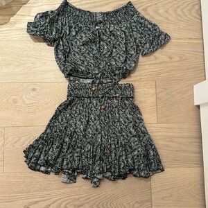 This is a Vintage Havana skirt set. It is black with a white pattern.